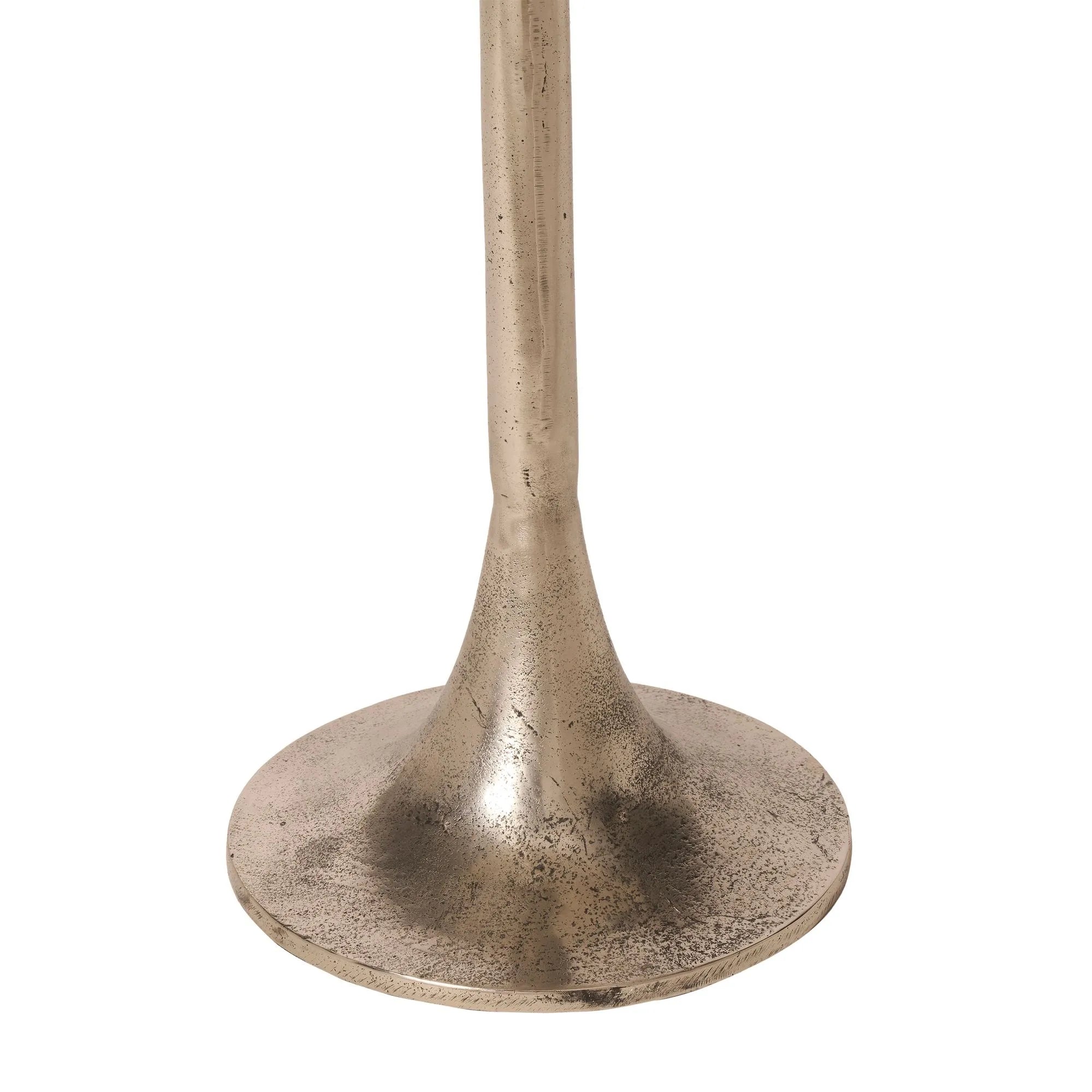 Close-up of the Eloa table base featuring a round, flared bottom and weathered, textured details in antique nickel finish.