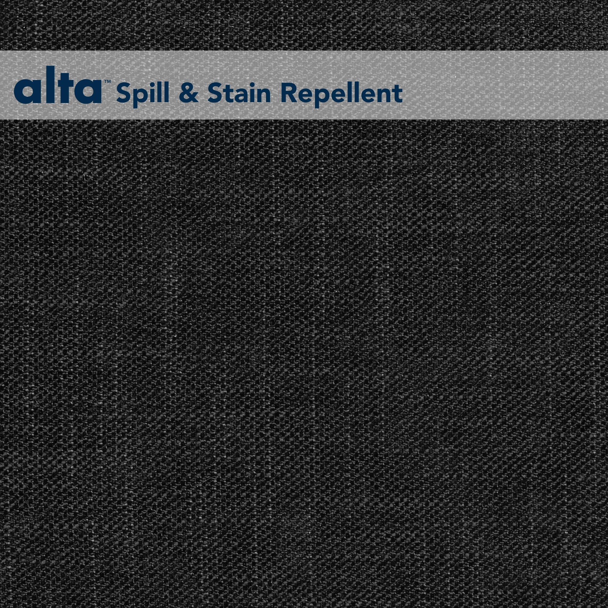A textured black performance fabric background called Tuxedo with a gray banner at the top displaying alta™ Spill & Stain Repellent in blue, emphasizing its stain resistant features.