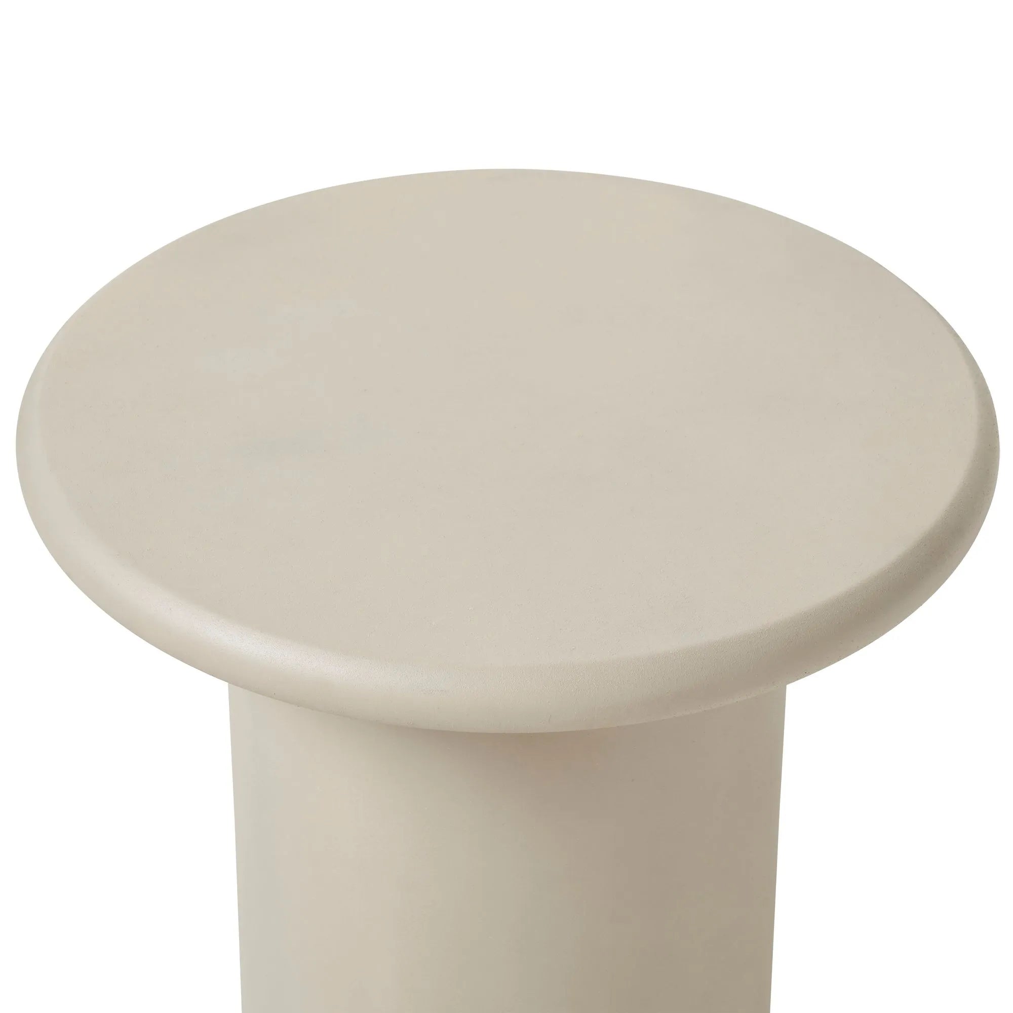 The Riya accent table features a round, beige surface with smooth, rounded edges and a sturdy cylindrical base—ideal for minimalist interior design.