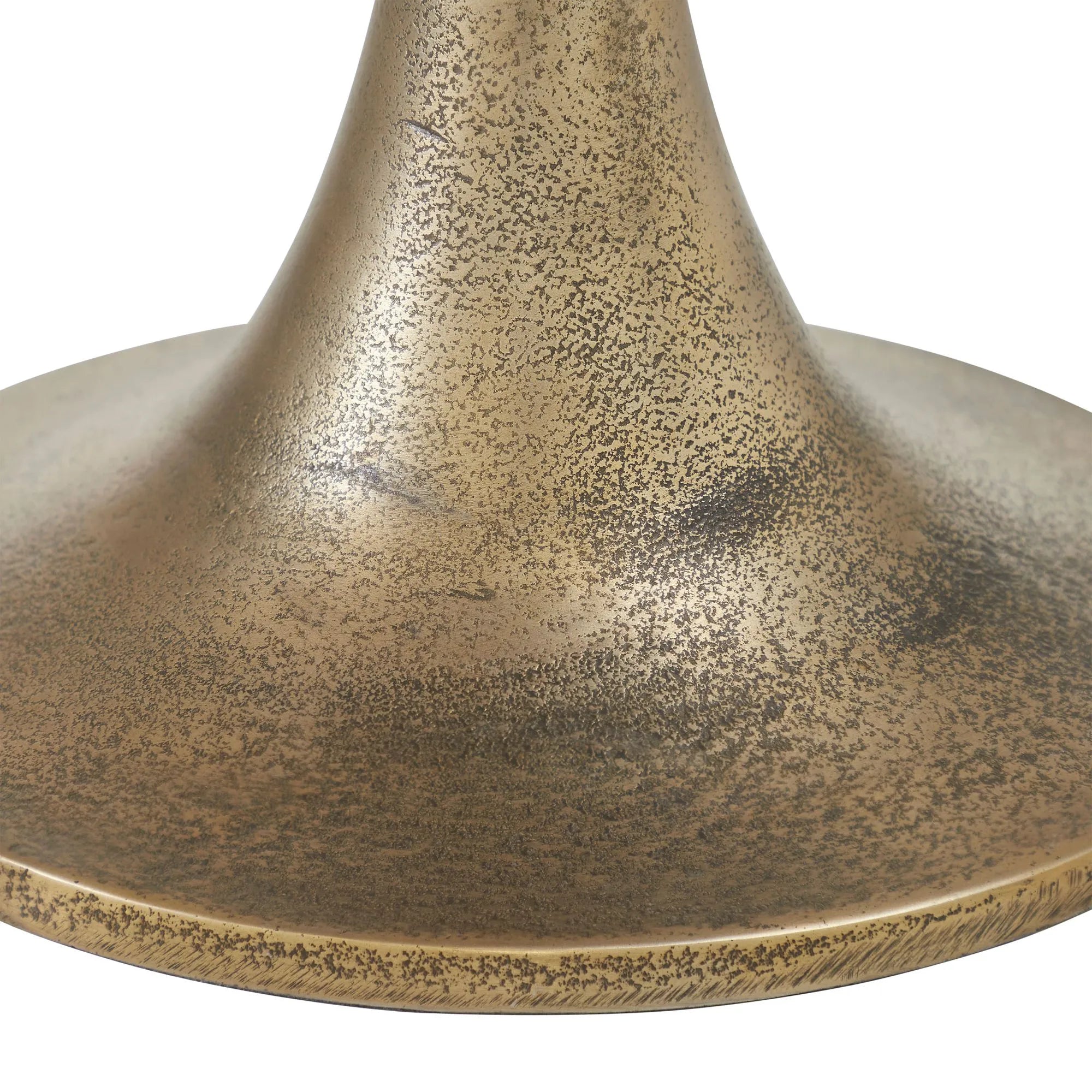 Close-up of Spartas tulip table base in textured antique brass—the flared edge and visible spots add character, making it a striking accent for a mango wood side table.