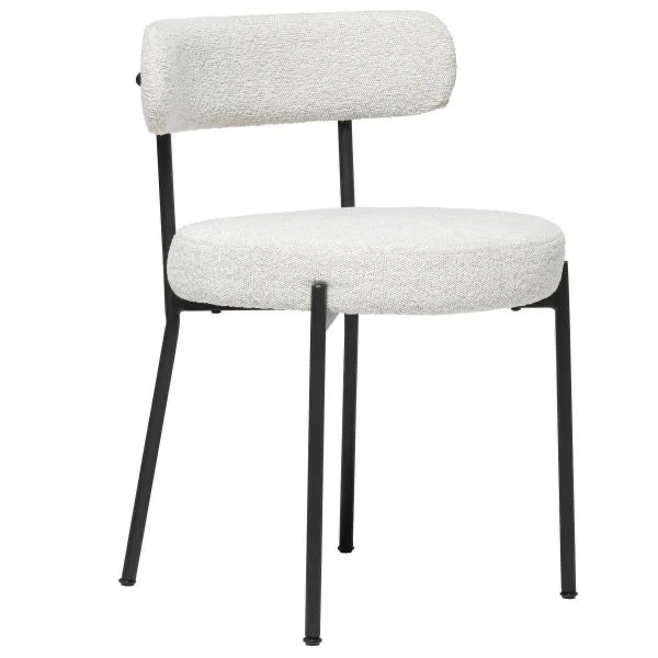 The Stacy Chair is a commercial-grade modern dining chair with a white upholstered seat and backrest, set on sleek black metal legs. Its minimalist design makes it ideal for any contemporary space.